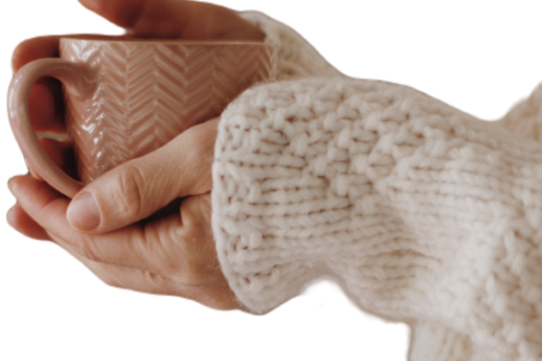 A women's hands holding a cup of tea