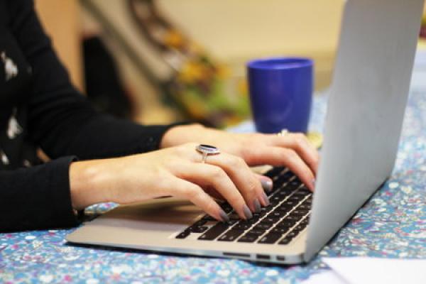 A pair of hands typing on a key board