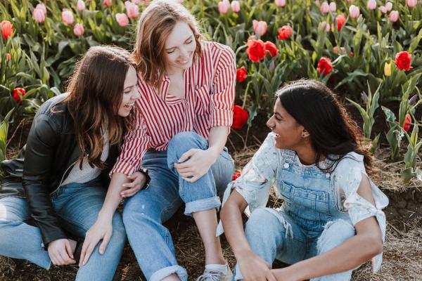 Group of women smiling and talking outdoors