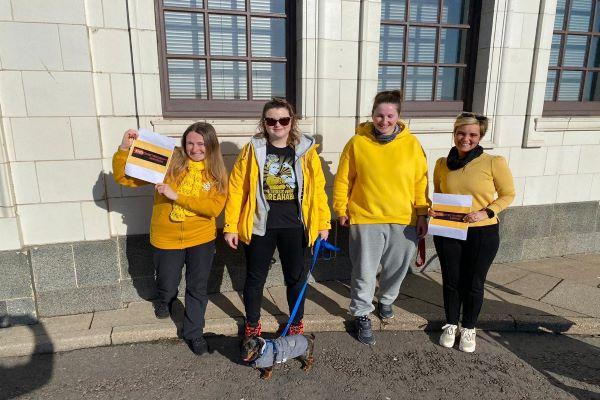 Volunteers in a yellow outfits.