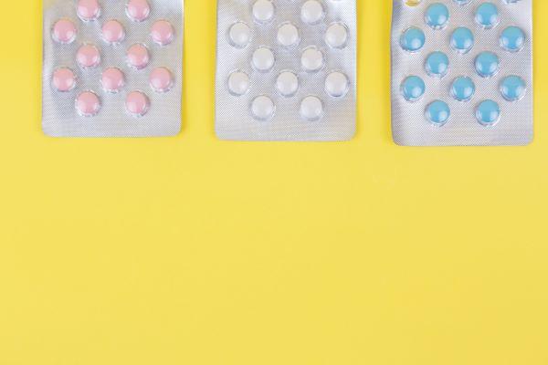 Pills in packets on a yellow background