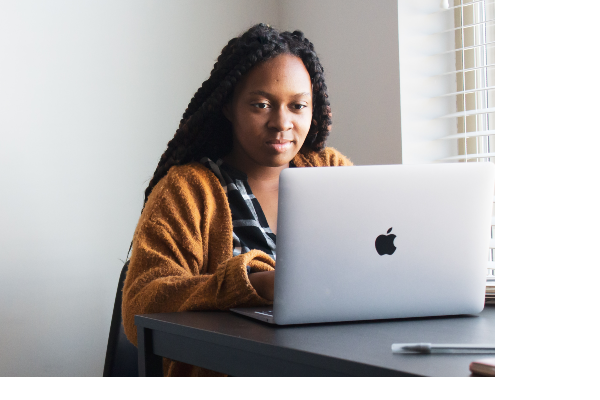 A woman looking at a laptop screen