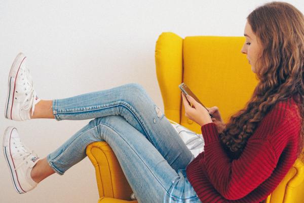 Woman sits on a yellow chair