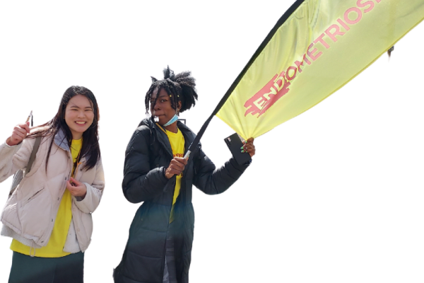 Two woman cheering runners at an event