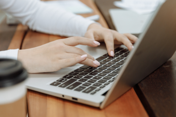 A person typing on a laptop