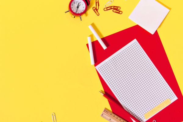 Red school supplies on a yellow background