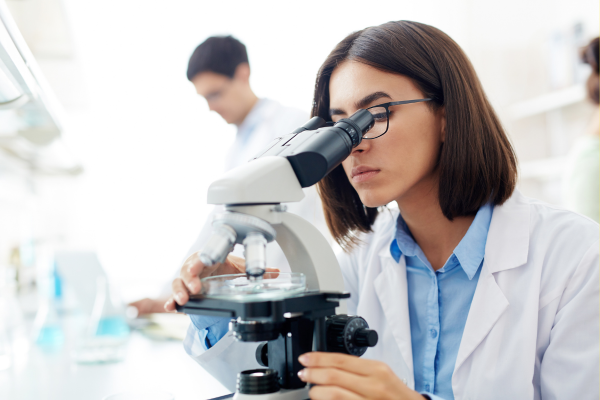 A photo of a researcher looking into a microscope